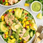 Salad with salmon filet, mango, avocado, bell pepper, cucumber and a creamy cilantro lime dressing.