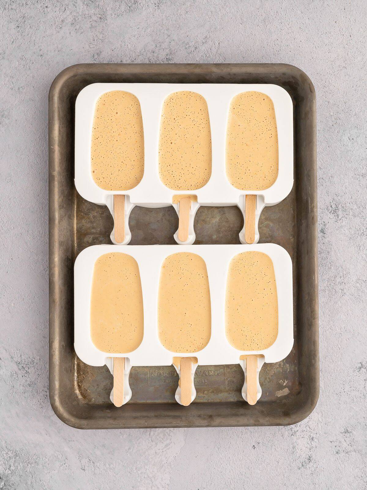 Unfrozen protein ice cream bars in silicone mold.
