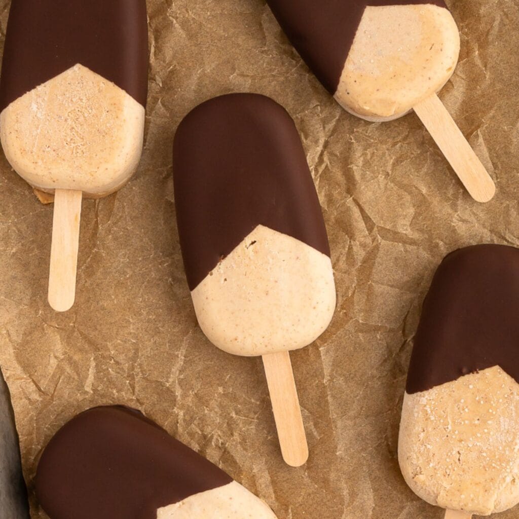 Tray of chocolate covered peanut butter protein ice cream bars.