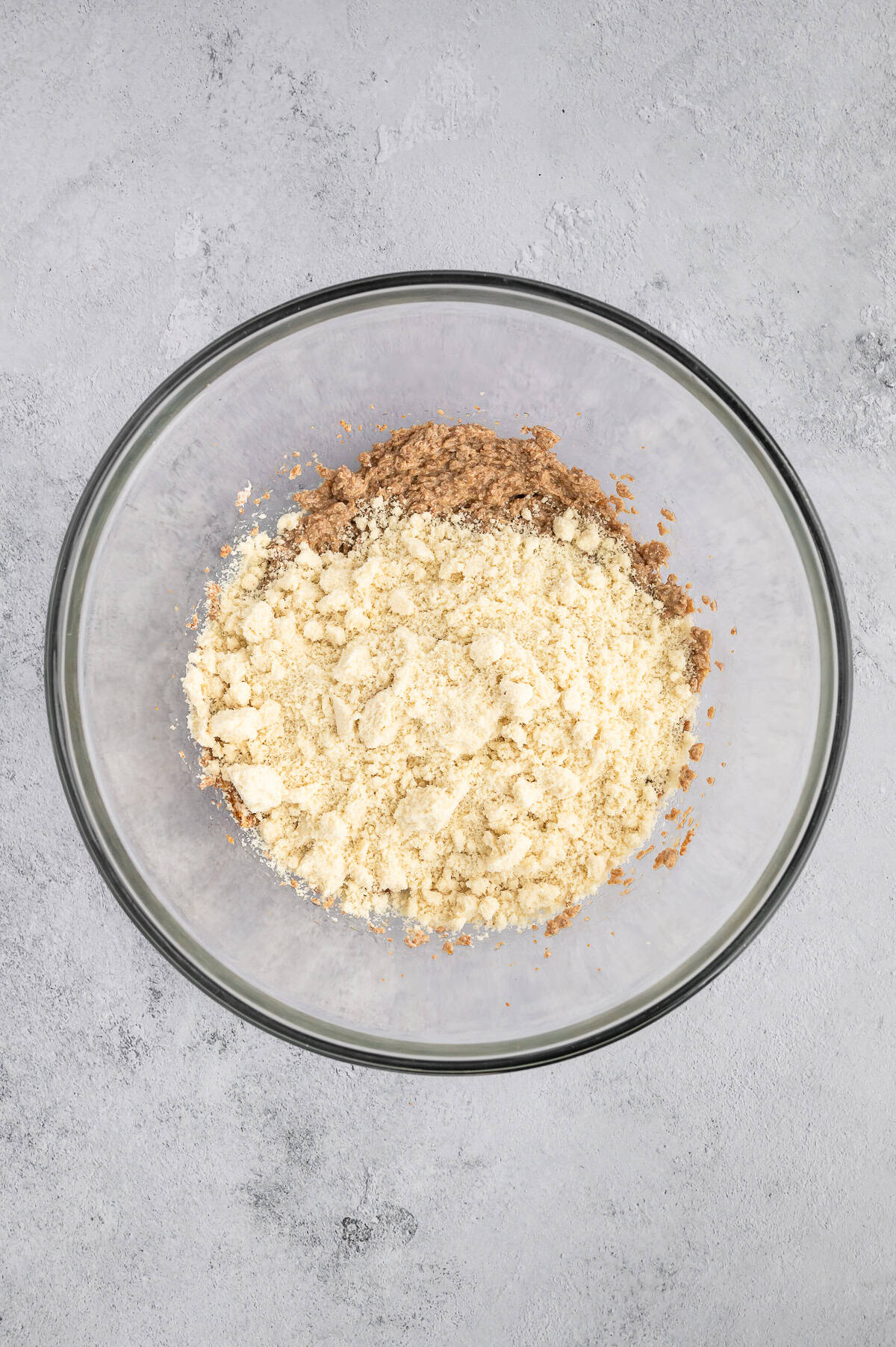Adding almond flour to mixing bowl.