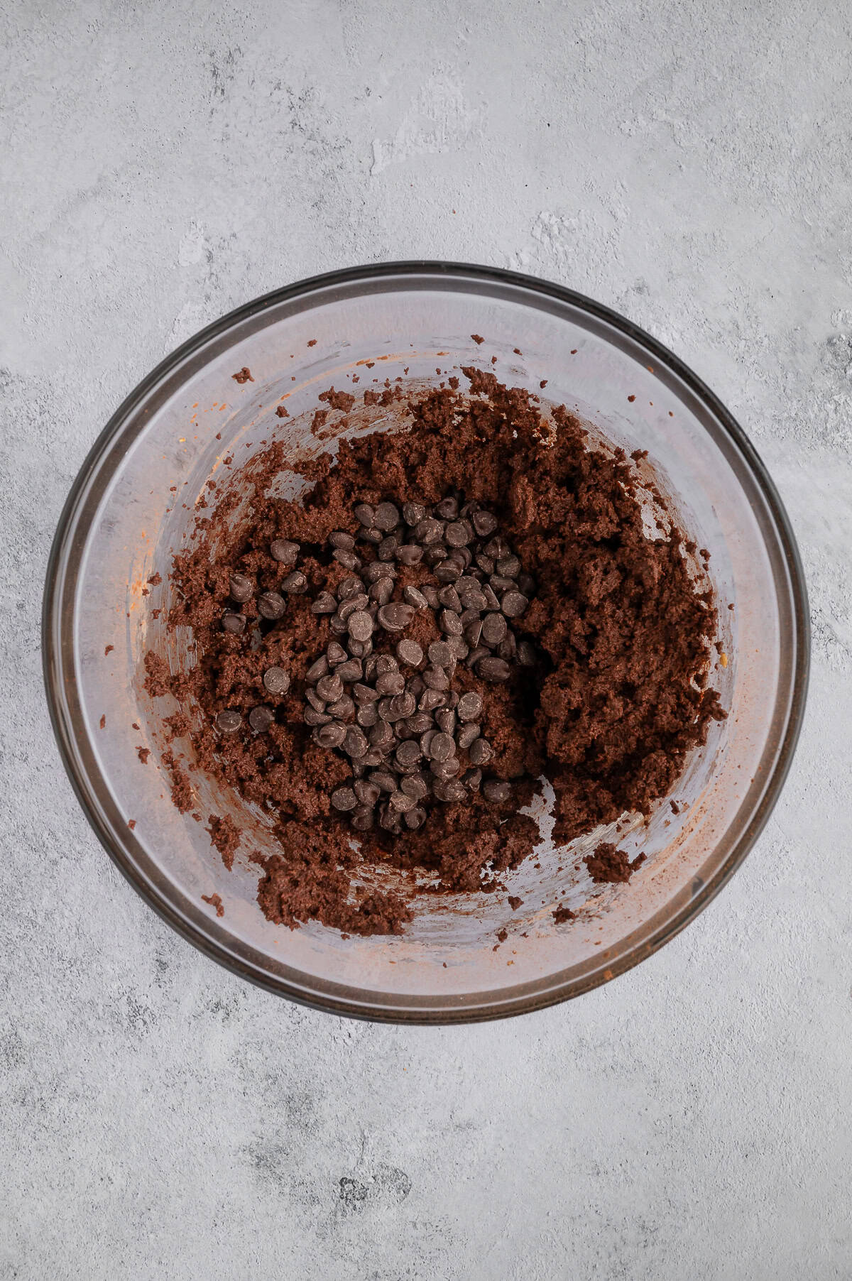 Folding chocolate chips into dough.