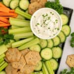 Cottage cheese ranch dip plated with veggies and crackers.