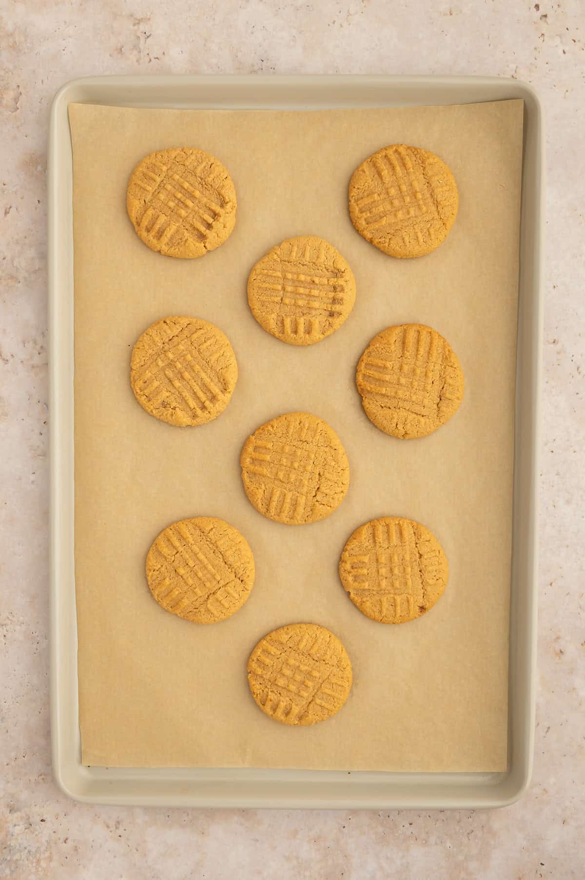 Baked almond flour peanut butter cookies on baking sheet.
