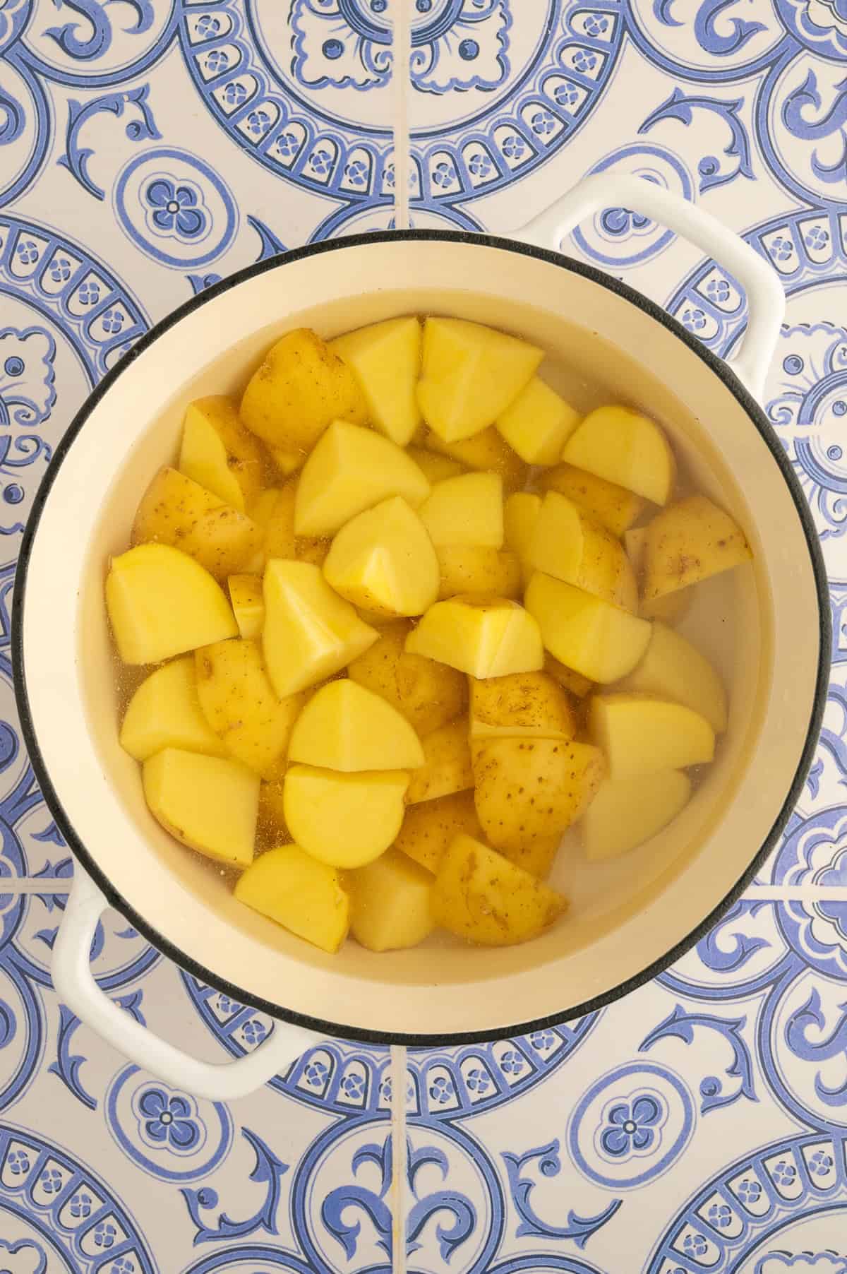 Boiling potatoes in a large stock pot.