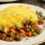 Close up of gluten-free shepherd's pie with carrots, beef and peas.