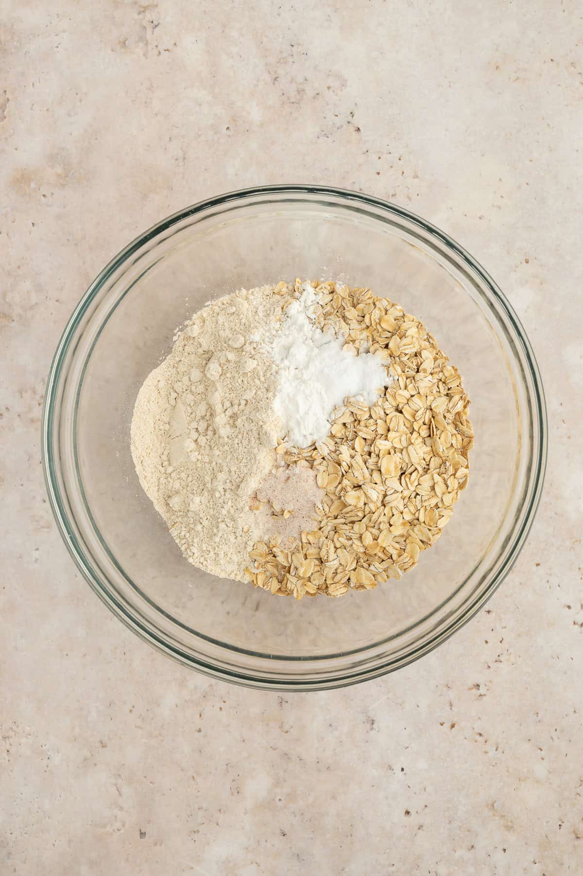 Dry ingredients for banana blackberry oatmeal muffins in a mixing bowl.