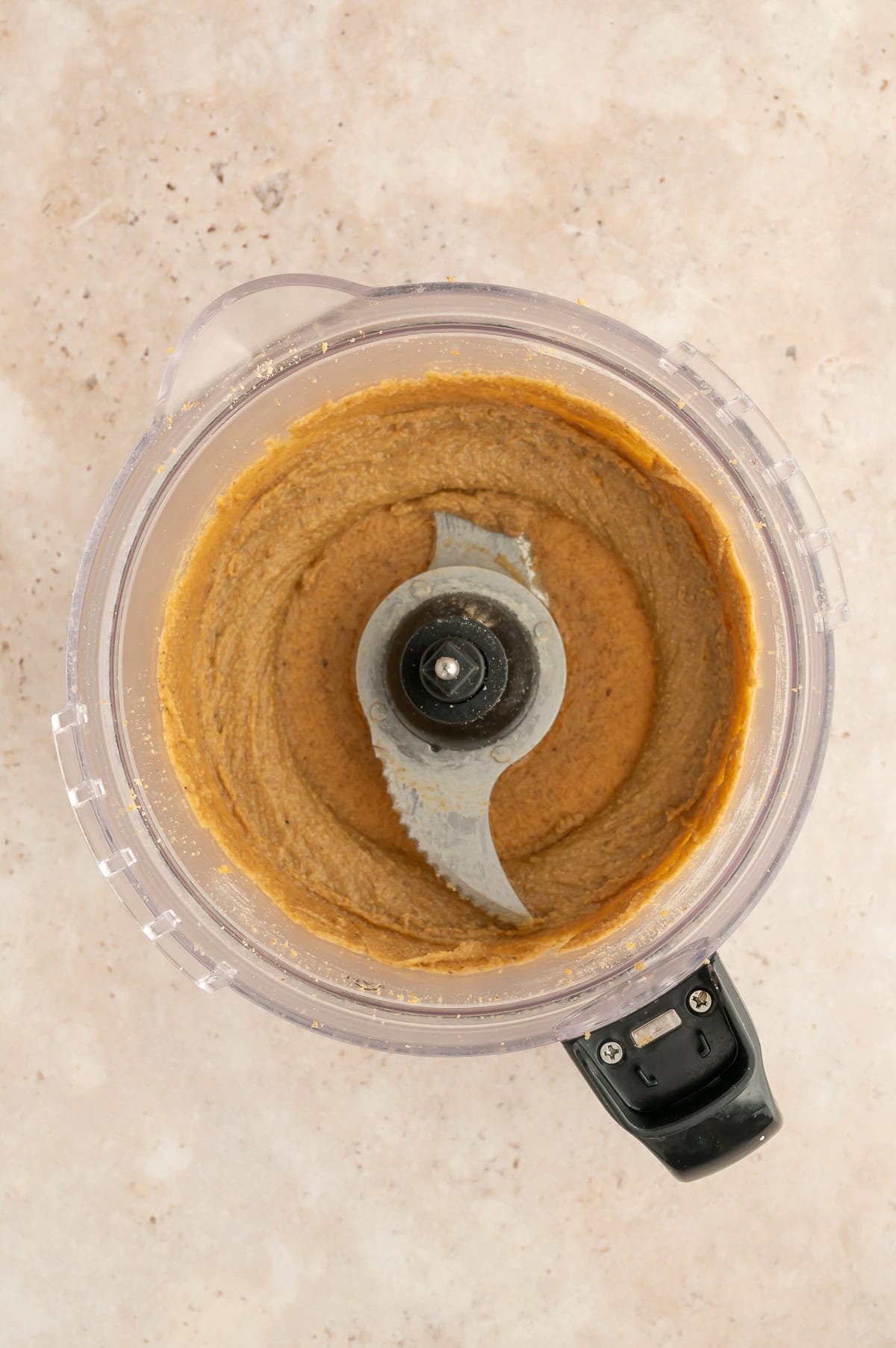 Fully mixed walnut butter in food processor.
