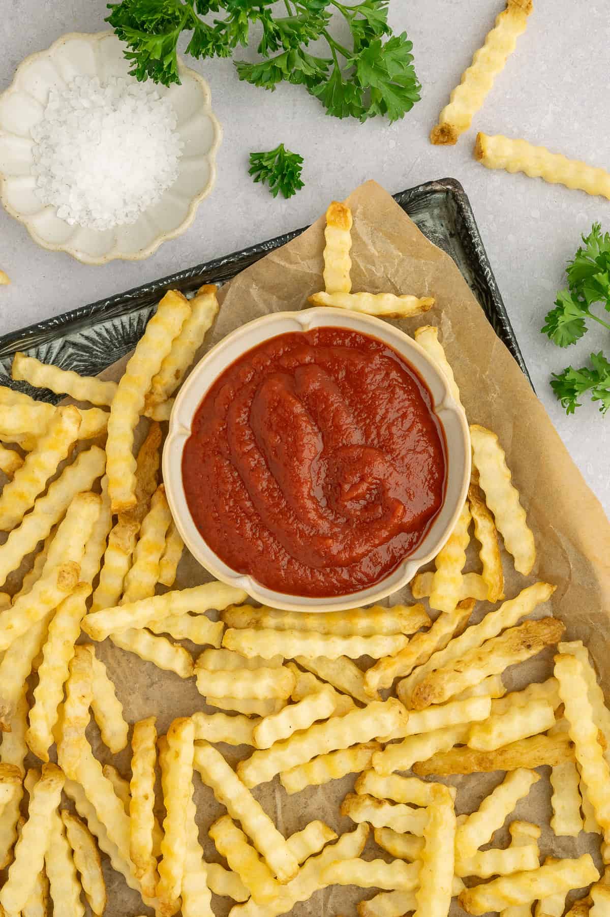Homemade no sugar tomato ketchup on a platter of fries.