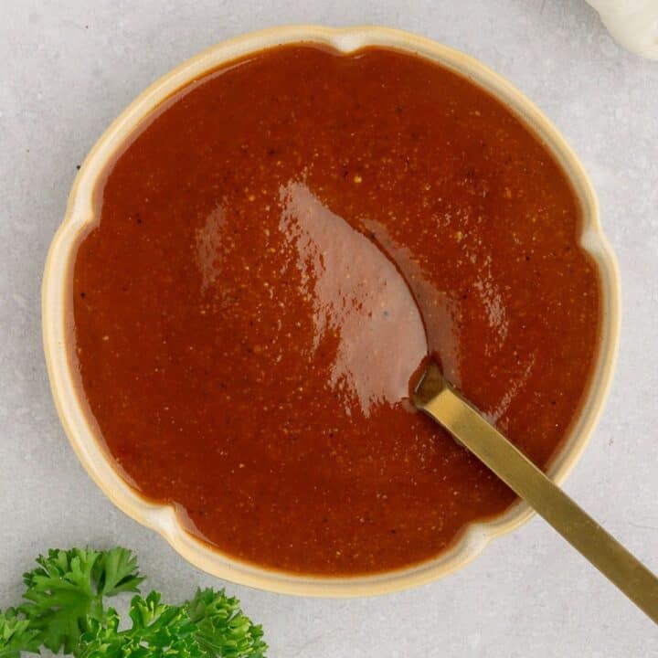 Dish of paleo BBQ sauce with a spoon in it.