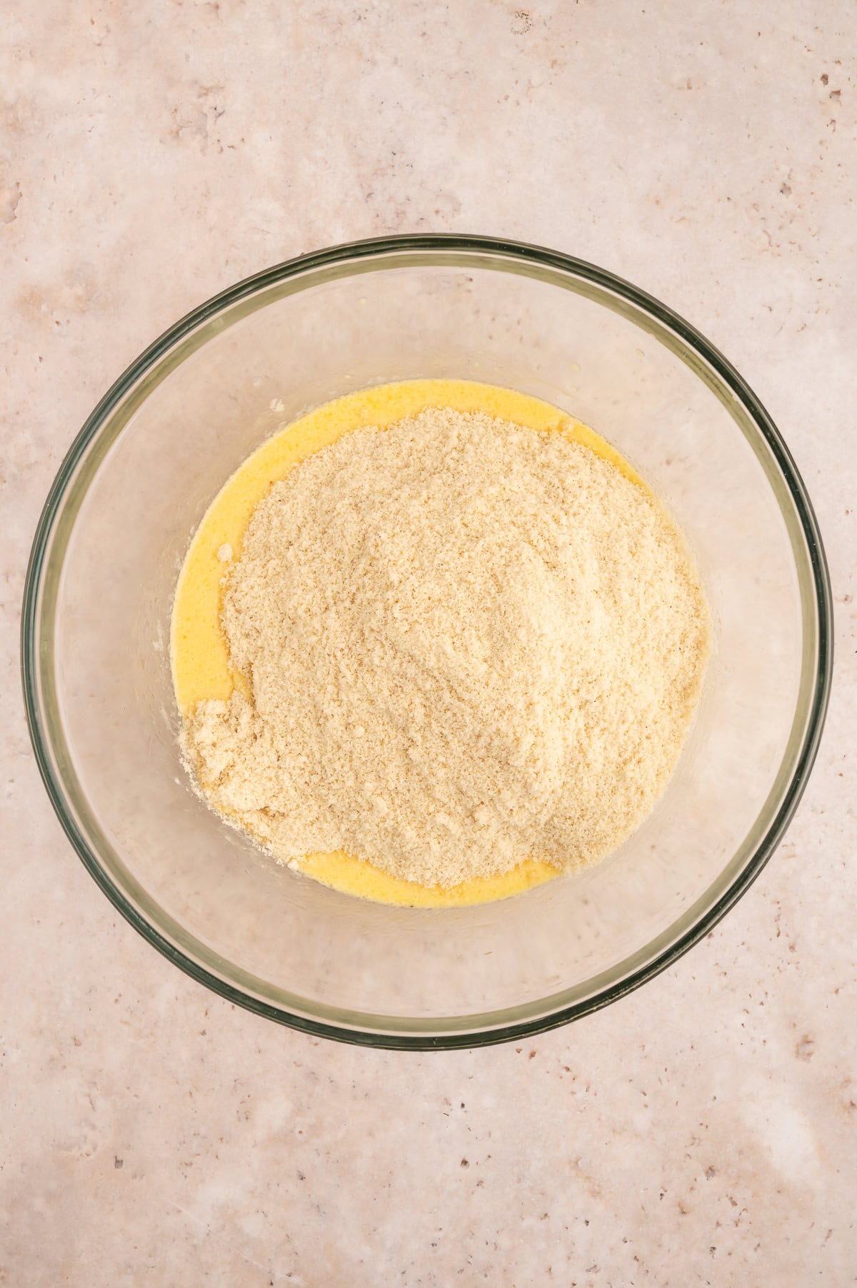 Combining wet and dry ingredients in mixing bowl.