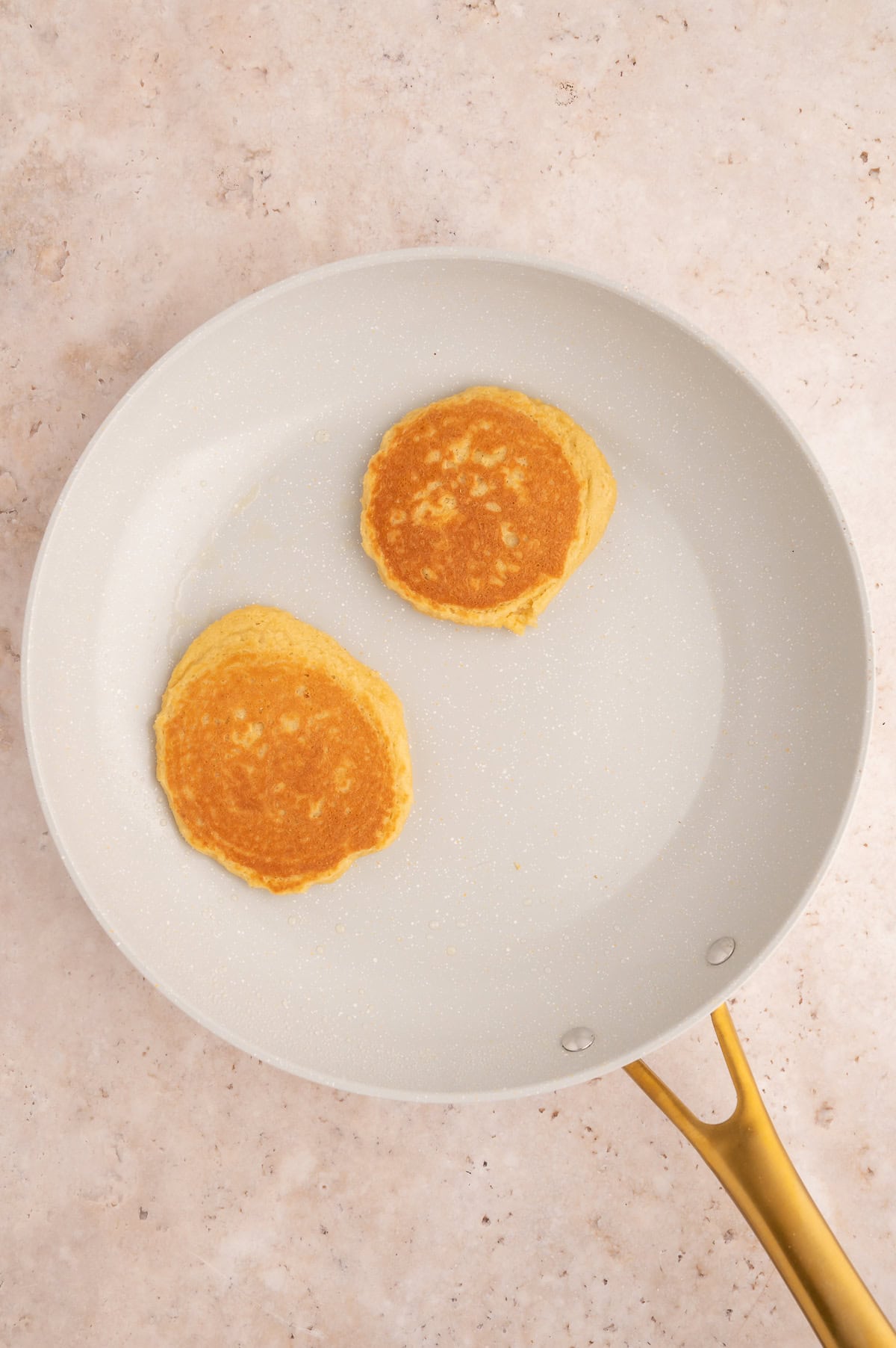 Flipping pancakes in a skillet.