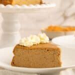 Slice of protein pumpkin cheesecake with whipped cream on top.