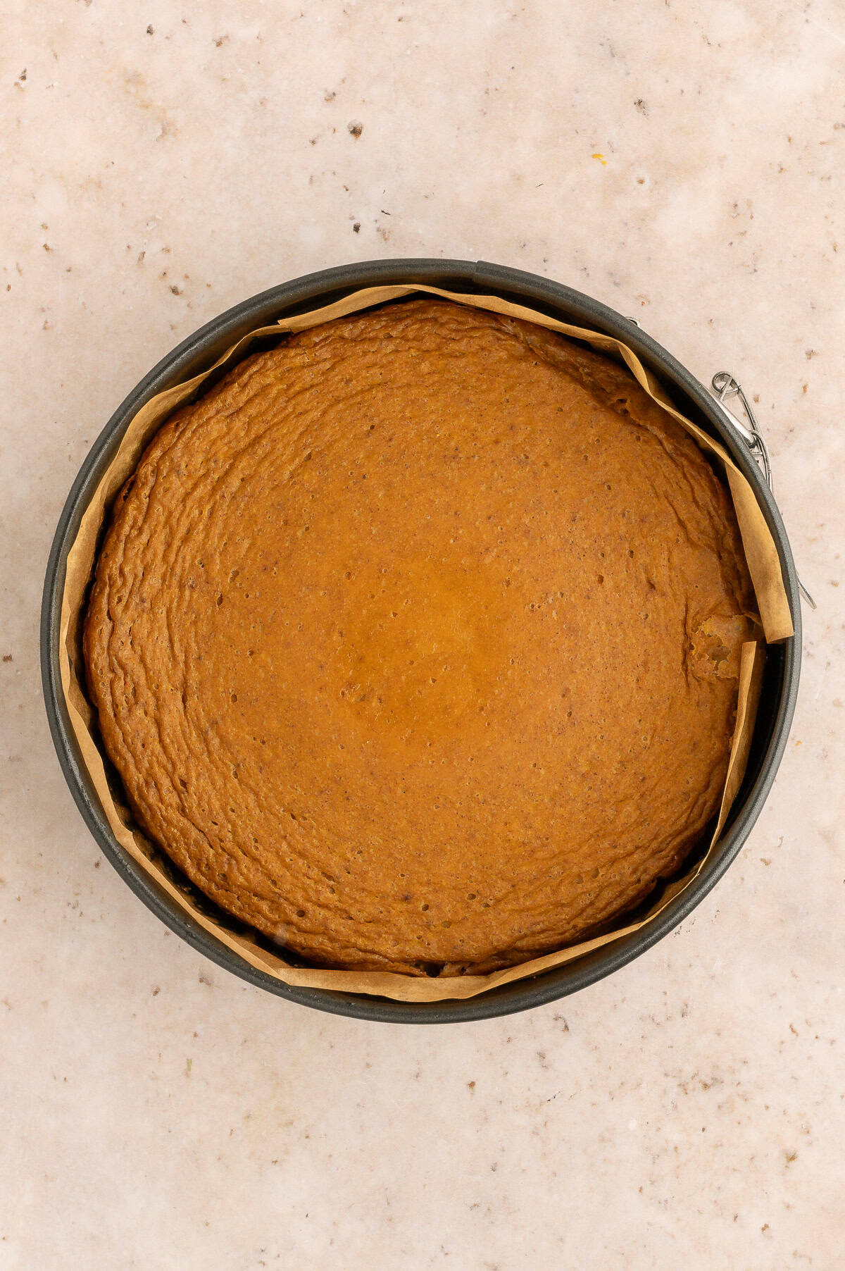 Baked protein pumpkin cheesecake in springform pan.