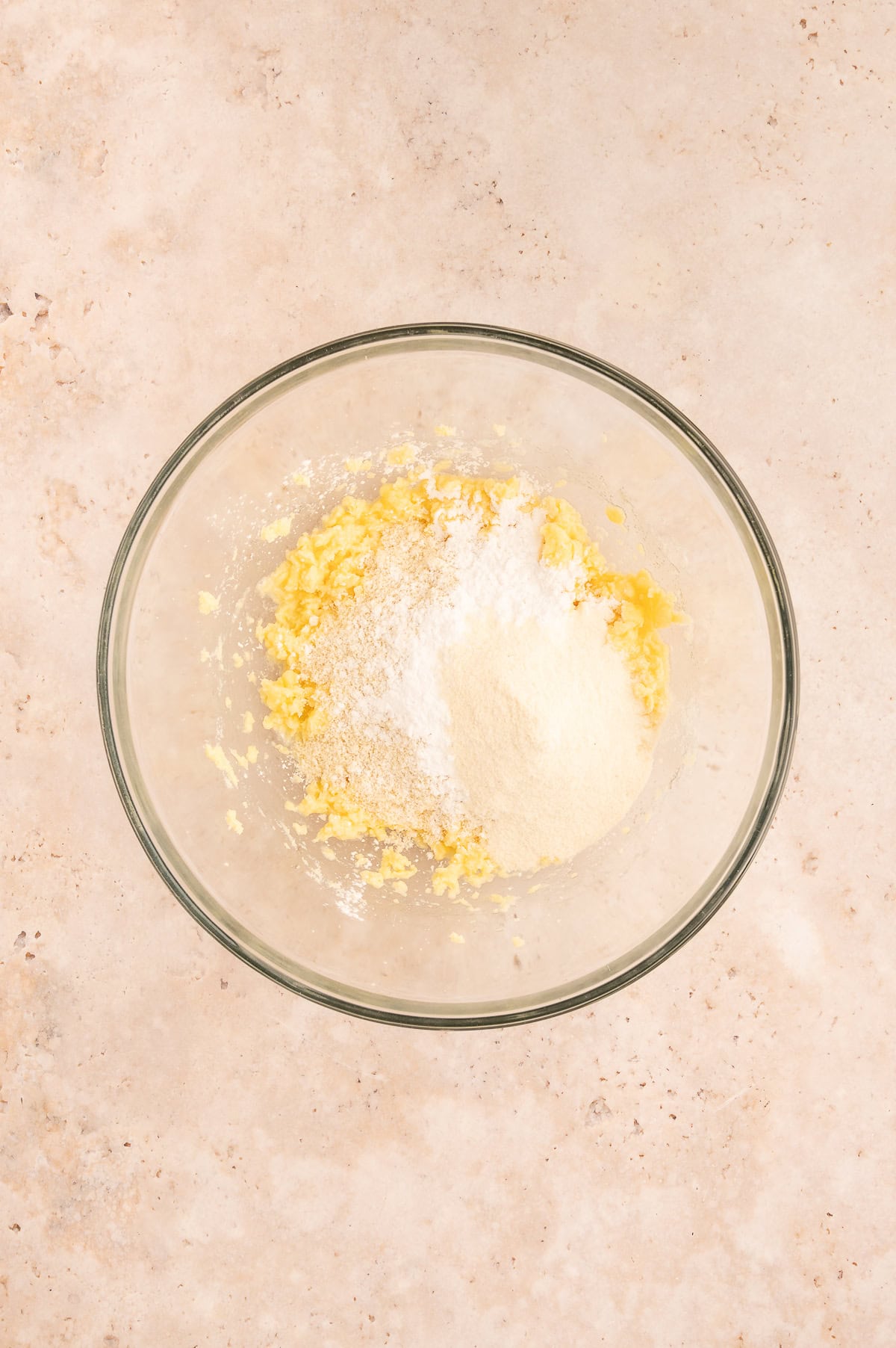 Adding almond flour, tapioca starch and coconut flour to mixing bowl.