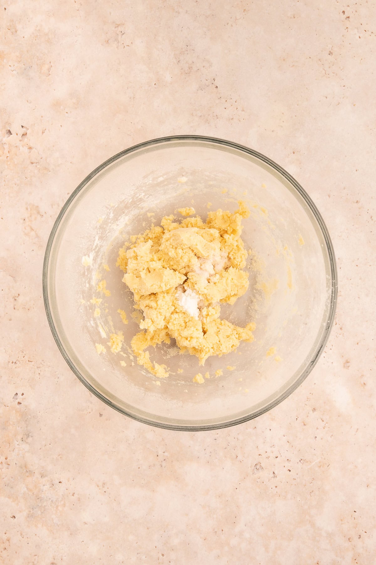 Adding baking soda and salt to dough in mixing bowl.