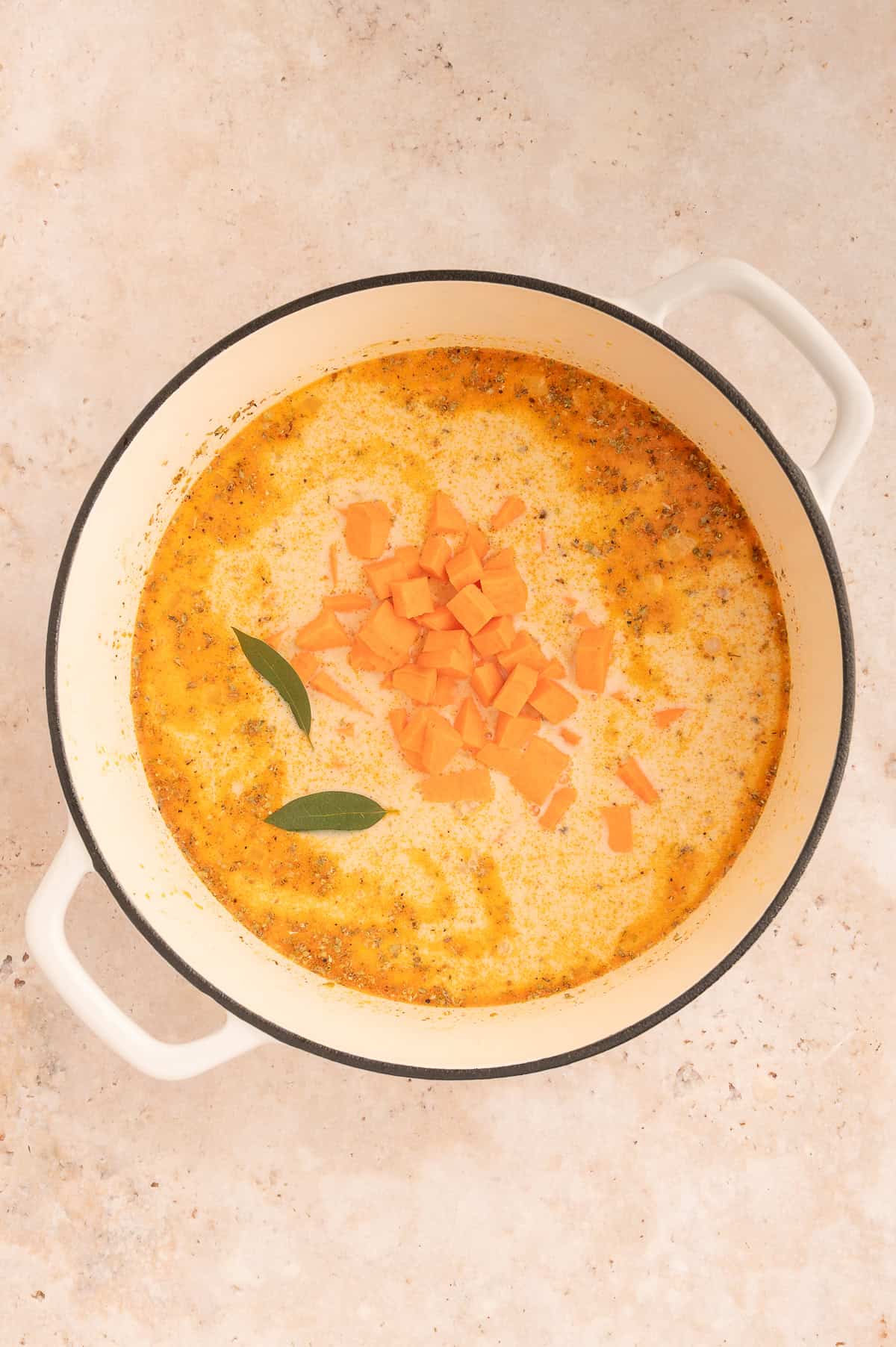 Sweet potato and bay leaves added to the stock pot.