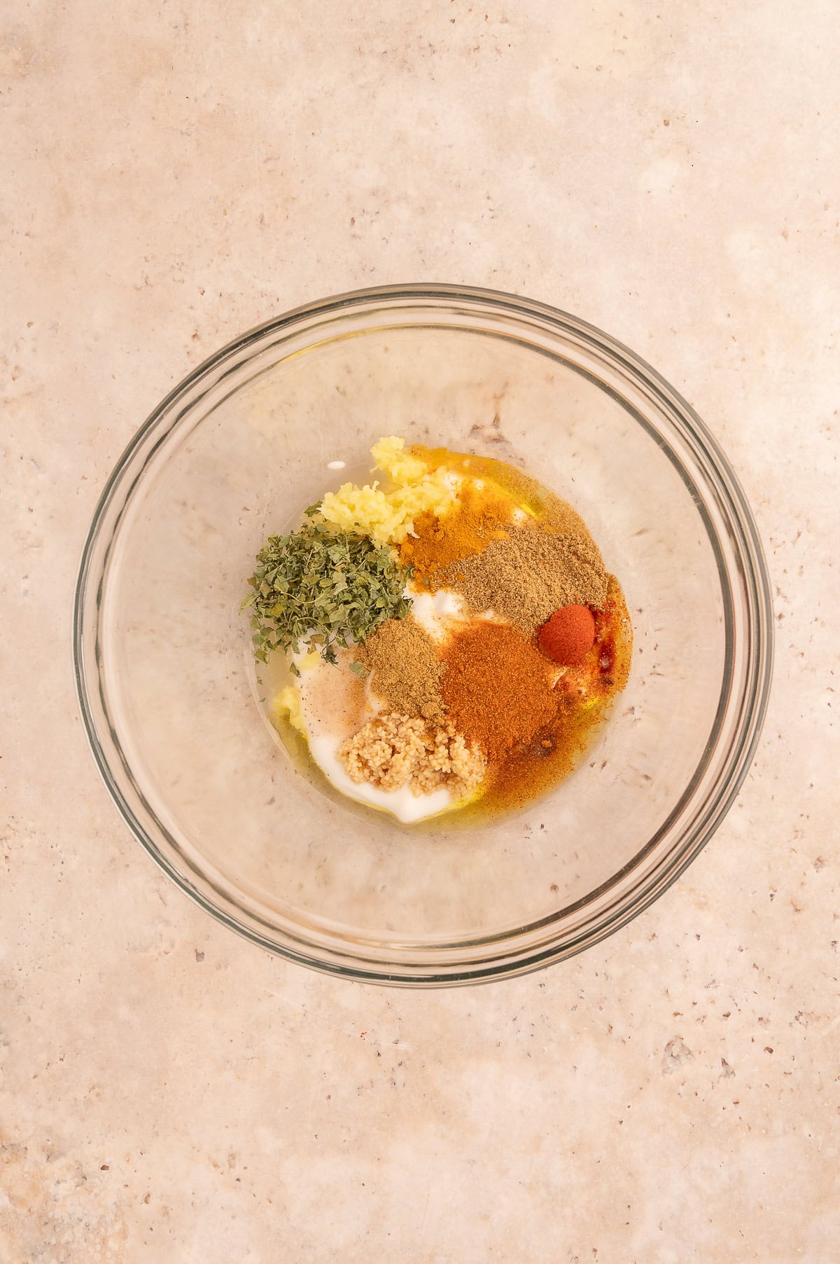 Mixing ingredients for tikka chicken marinade in a large mixing bowl.