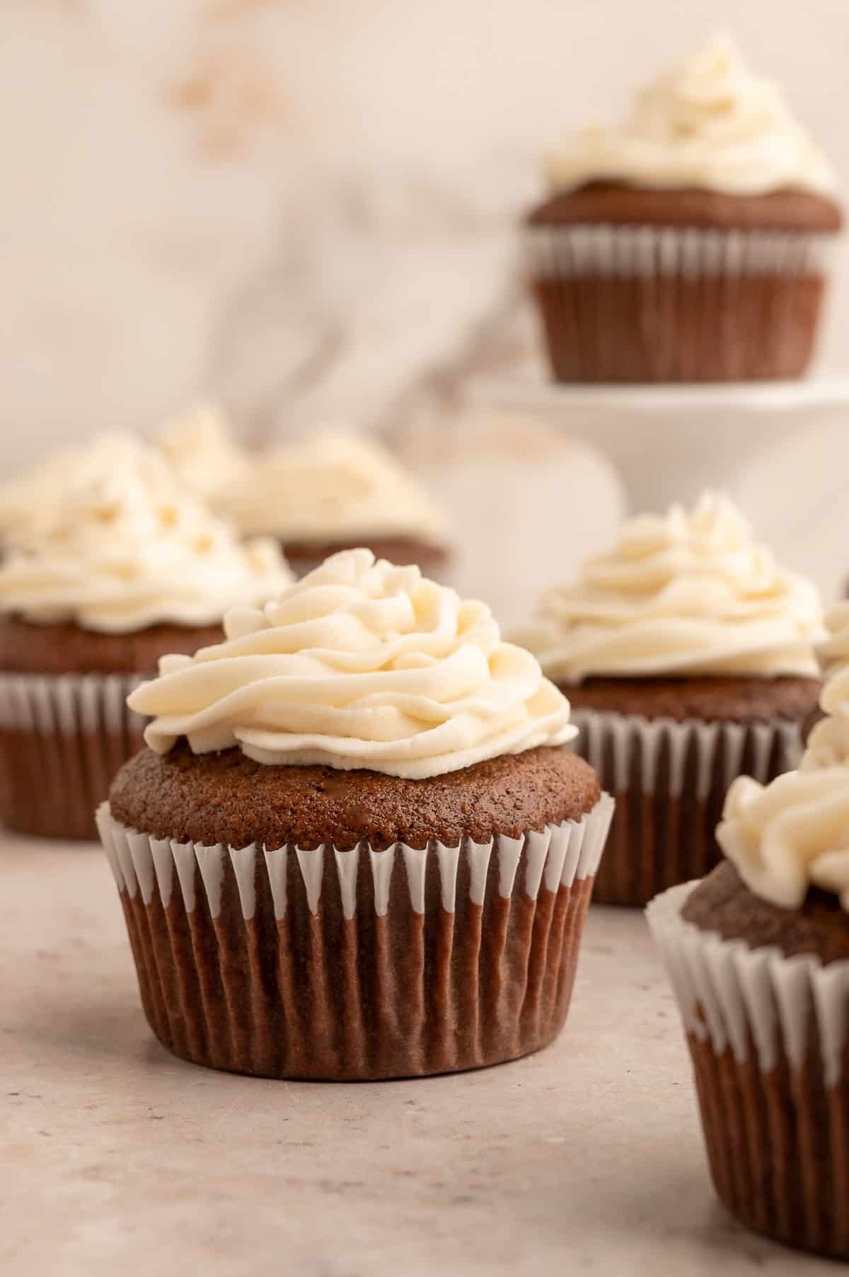Almond flour chocolate cupcakes with a swirl of white frosting on top.