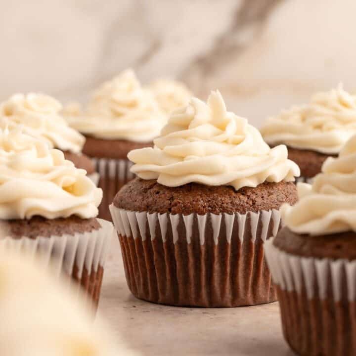 Almond flour chocolate cupcakes with a swirl of white frosting on top.