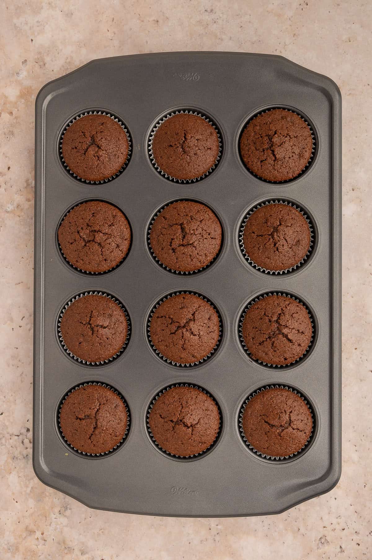 Almond flour chocolate cupcakes baked in a muffin tin.