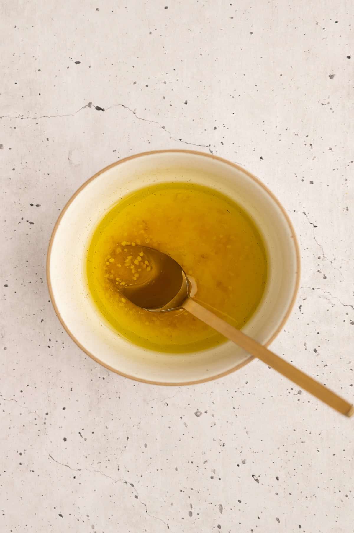 Dressing for salad in a small bowl.