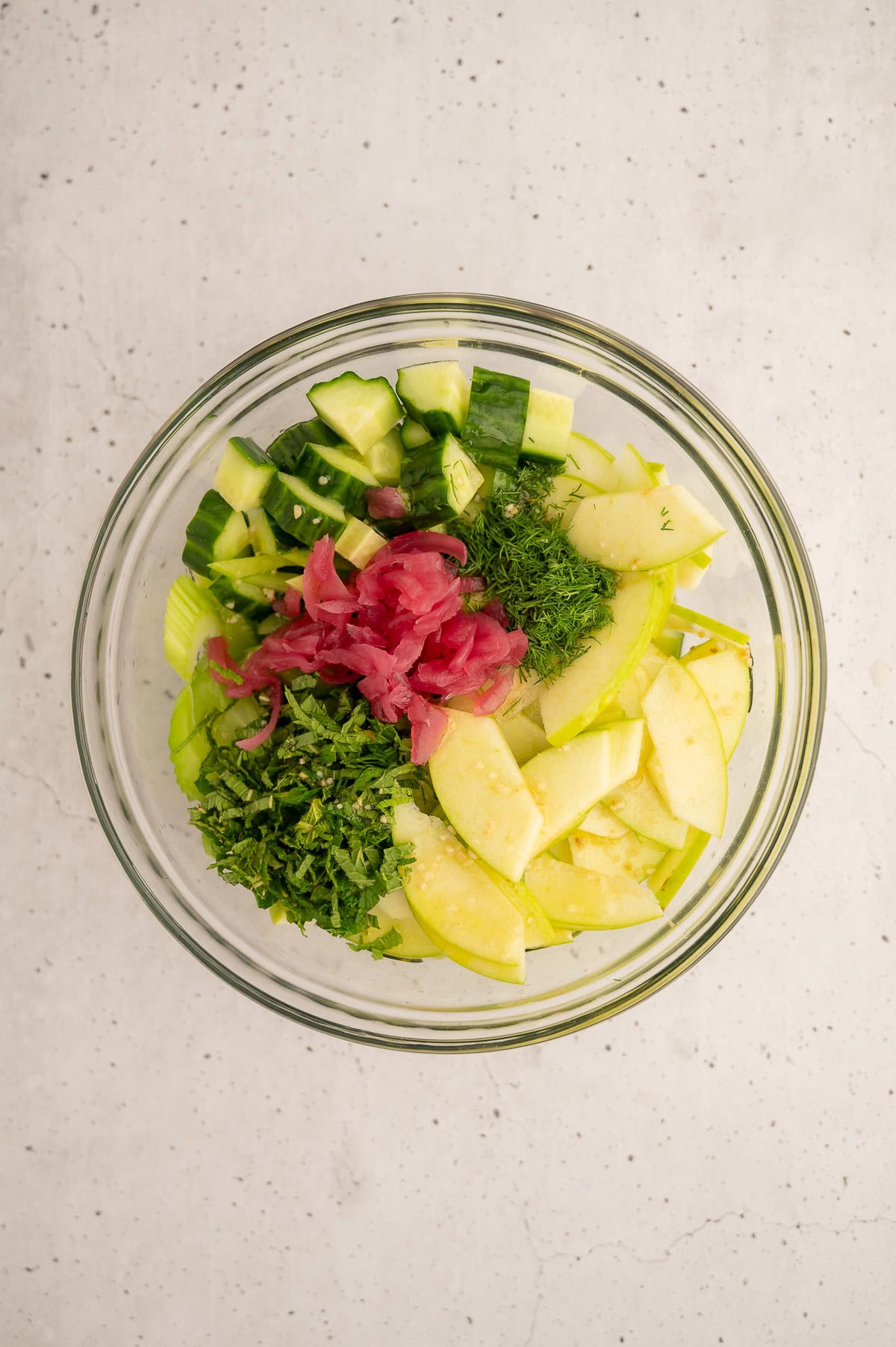 Chopped ingredients for cucumber celery salad in a mixing bowl.